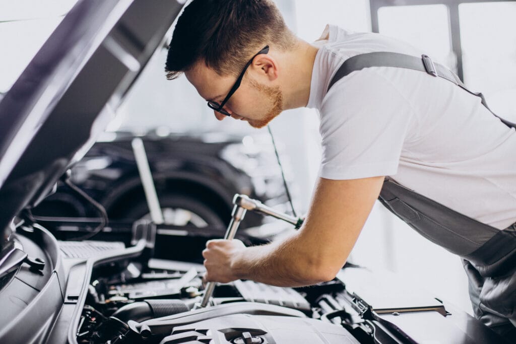 Repair man making car service